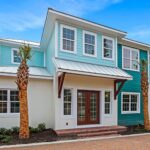 The Duval two story home at Ponce Inlet Key, built with Key West style design and light blue exterior finish on upper floor